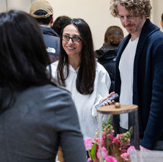 Friendly conversation between vendor and visitors at Pomexpo Norooz Bazaar