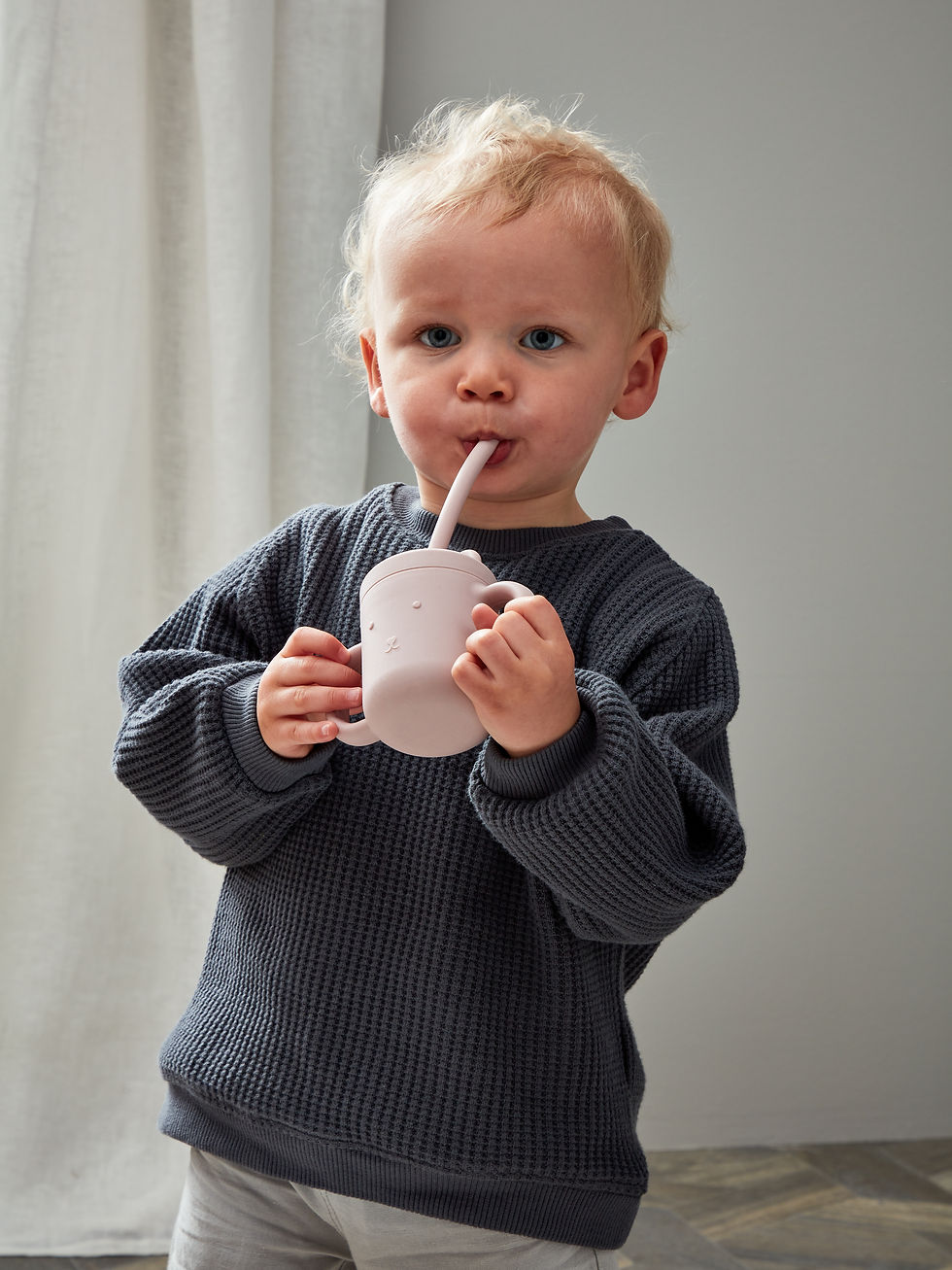 young boy drinking out of eco friendly cup