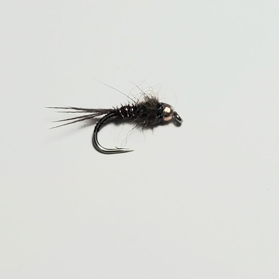 Close-up fishing nymph fly: Brown possum dubbing body, brown pheasant tail tied on a #12 or #16 grub hook