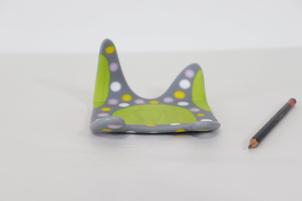 fused glass art object blending contemporary craft and modern design with gray glass and colorful polka dots