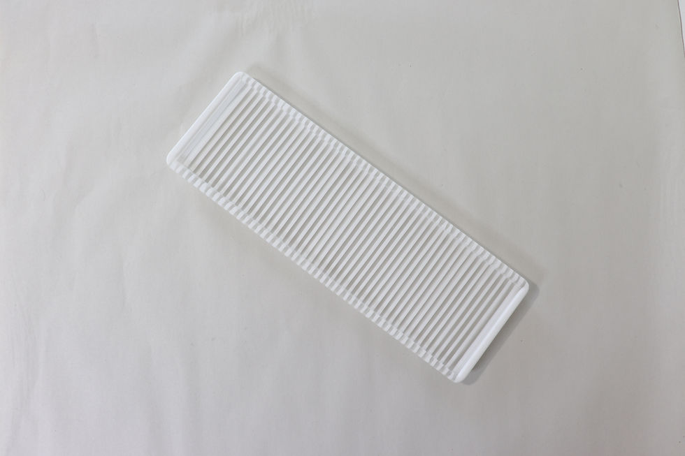 one of a kind fused glass art object featuring an alternating white and clear striped design above
