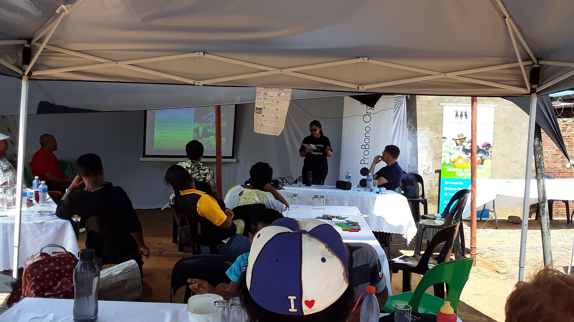 Lady presenting a slideshow; showcasing women and law along with mediation academy supporting  the presentation.