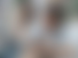 the wife checking on his husband while he is looking at his mobile phone