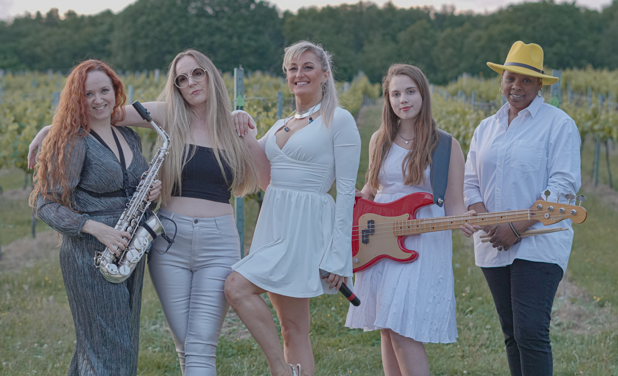 Beautiful women standing with musical instruments