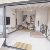 View from a blacony into a living area through sliding glass doors