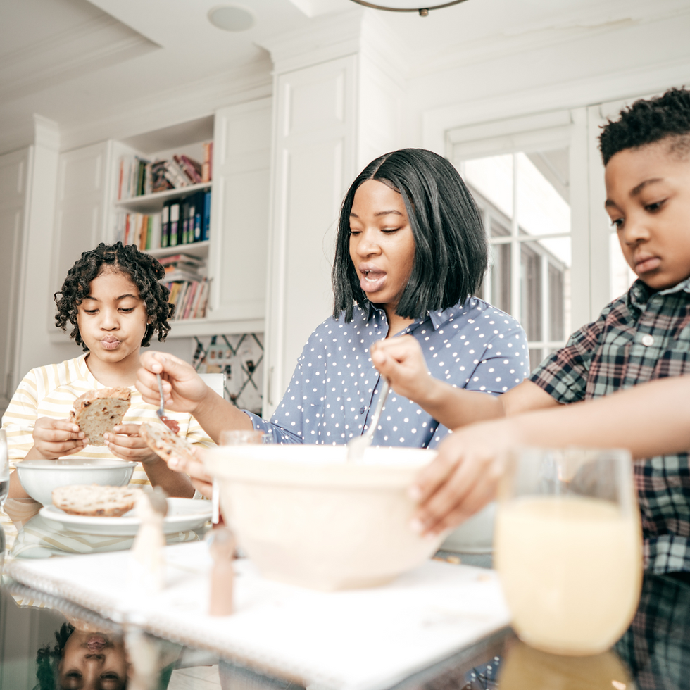 Family enjoying breakfast together as part of a morning routine, highlighting the importance of raising organized kids with habits and systems.