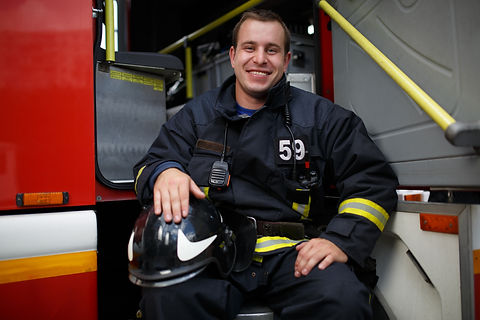Photo of happy fireman looking at camera