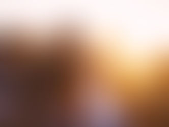 four friends hugging and watching a sun rise.