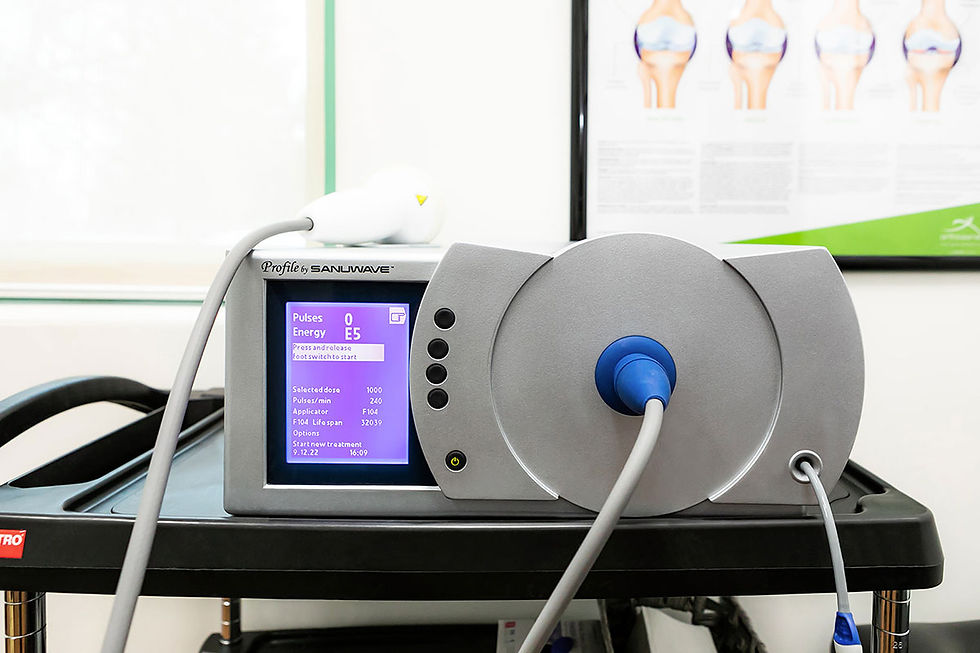 Close-up view of shockwave therapy device head positioned near a patient’s shoulder