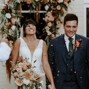 Bride and groom with bespoke wedding flowers including a handcrafted bridal bouquet and buttonhole.
