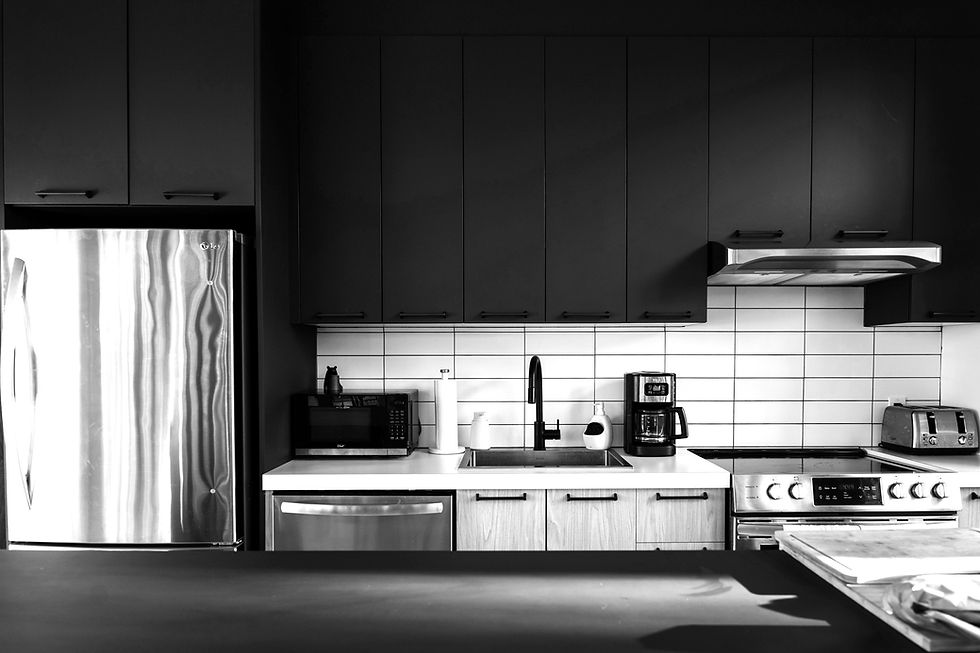 High-resolution modern kitchen with dark upper cabinets, light wood lower cabinets, and white tile backsplash.