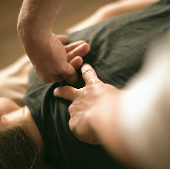 a woman laying on top of a bed holding a mans hand_edited.jpg