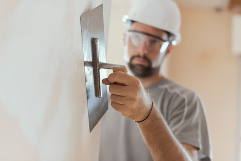 professional-craftsman-applying-plaster-with-a-tro-2021-08-26-22-39-57-utc.jpeg