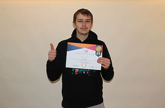 Teenager holding award certificate, thumbs up