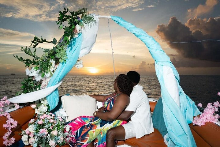 Romantic private boat charter setup in Turks and Caicos with decorated canopy and couple watching th