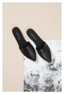 a pair of black Warehouse shoes on a white marble surface