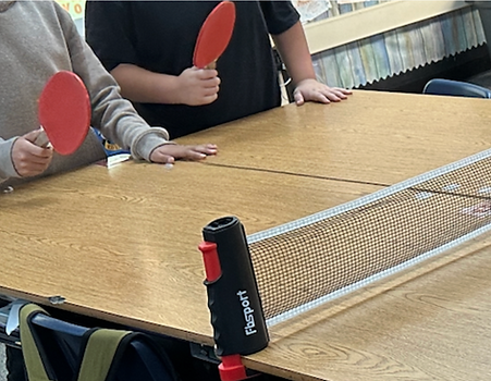 Students enjoying ping pong on a rainy day!