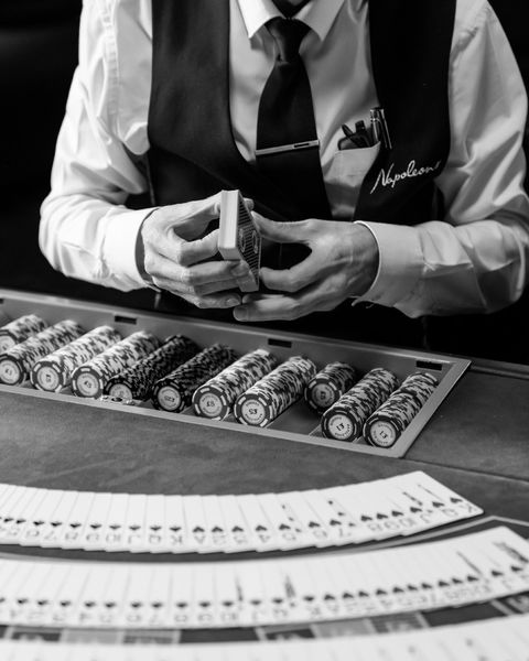 casino dealer in bespoke black waistcoat with embroidery