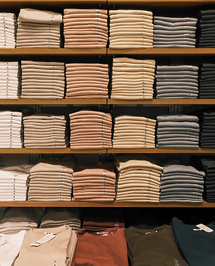 Neatly stacked clothes displayed on shel