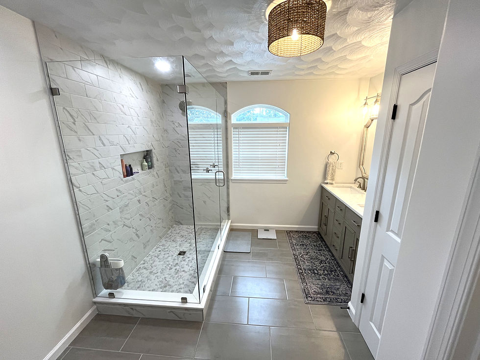 Master bath remodel. Walk-in glass shower, marble tile, gray penny tile floor, double vanity, quartz counter, nickel fixtures, tile floor.