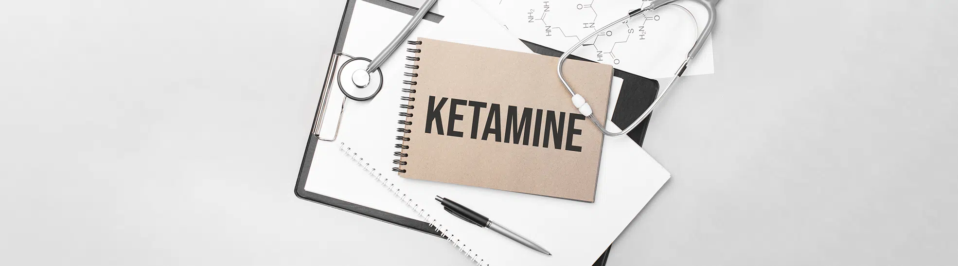 Inscription Ketamine. Top view of the table with stethoscope, pen and medical documents. Health care concept copy