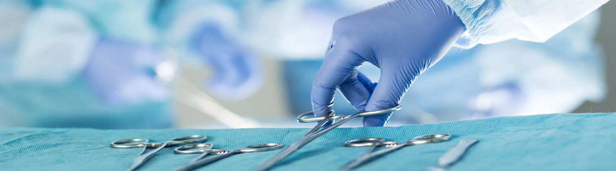 Close up of scrub nurse taking medical instruments copy