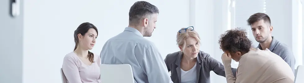 Rehab group therapist comforting woman