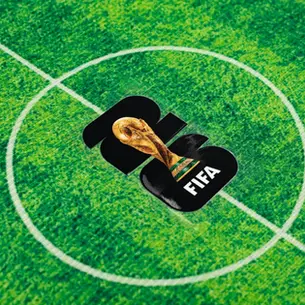 FIFA World Cup trophy on a green soccer field at midfield circle, with white pitch lines and black 2022-style graphic.