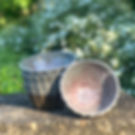 stack of faceted handmade pottery bowls on rustic outdoor stone bench