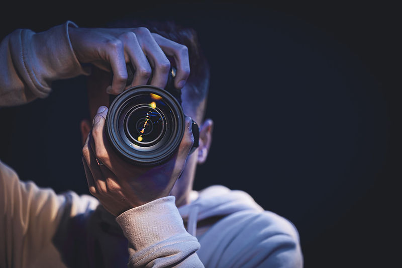 a-man-photographer-with-a-camera-takes-a-photo-in-2021-12-14-02-43-34-utc.jpg