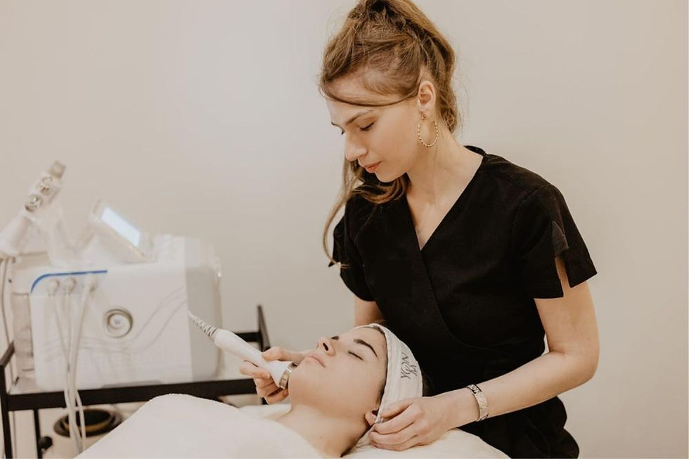 Esthetician applying a facial mask during a professional skin-smoothing treatment