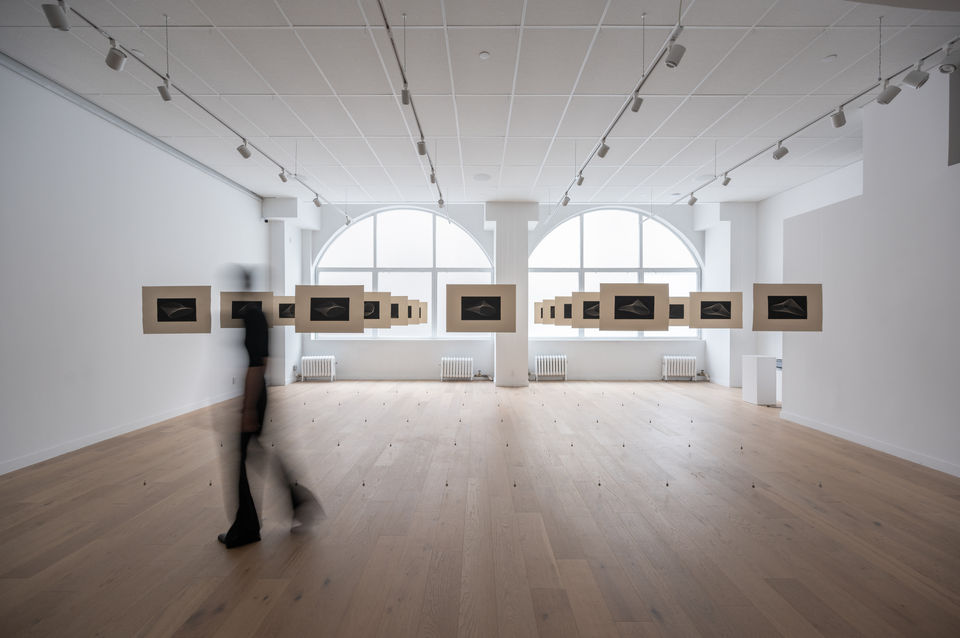 Installation view of An End Has a Start by Yiyi Wang at THE BLANC, featuring 25 prints arranged in a 5×5 grid depicting a Möbius strip from shifting angles.