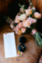 a bouquet of pink flowers lying on a wooden desk