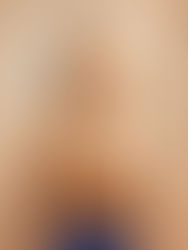 A female sim modeling a long, sleek, and straight hairstyle featuring a classic, clean middle part.
