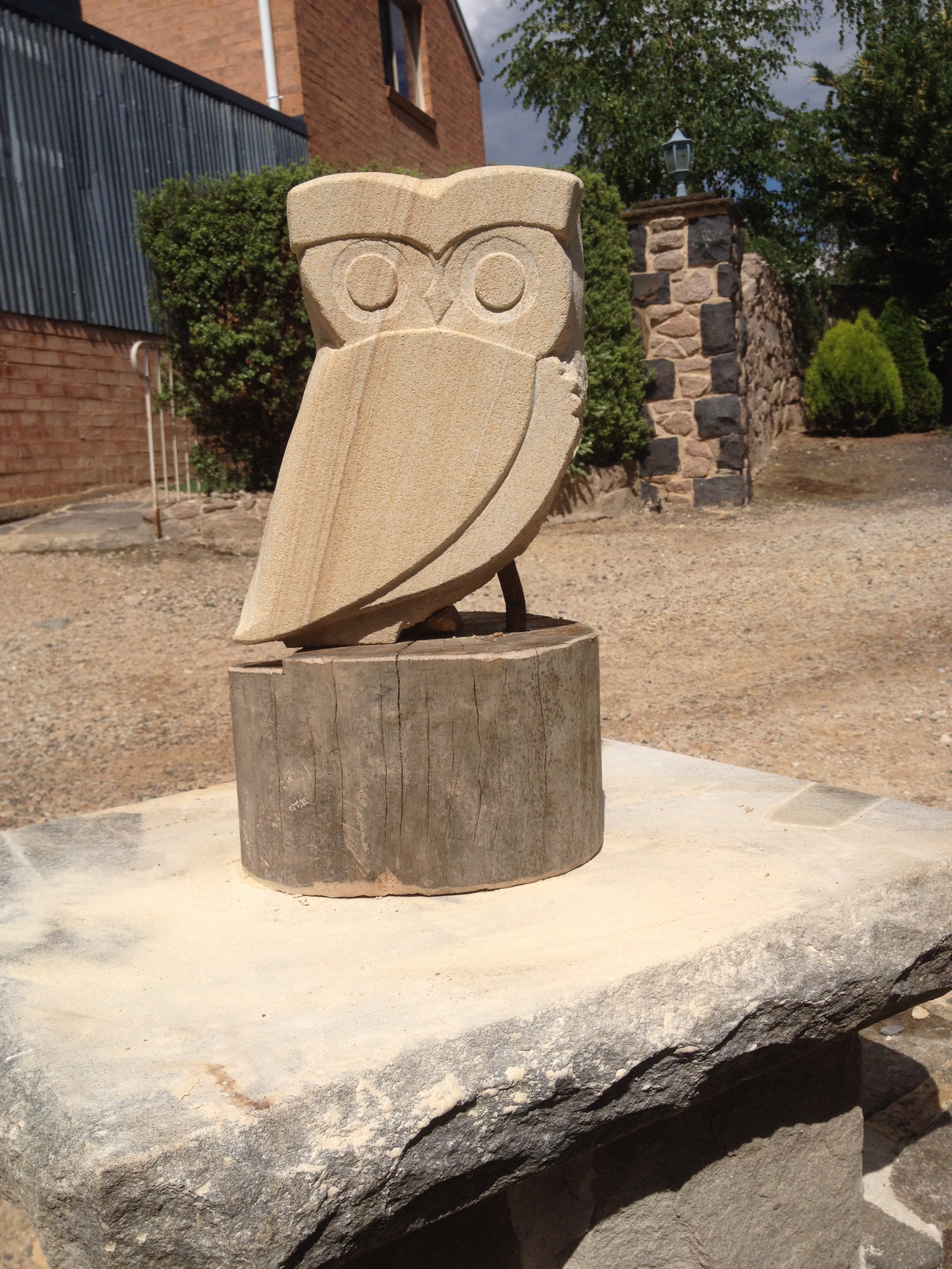 Sandstone owl on timber base