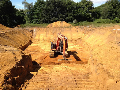 Orange digger digging hole