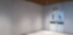 Double fire doors with fire exit sign above in white corridor