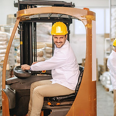 employee-driving-forklift-warehouse-min.jpg