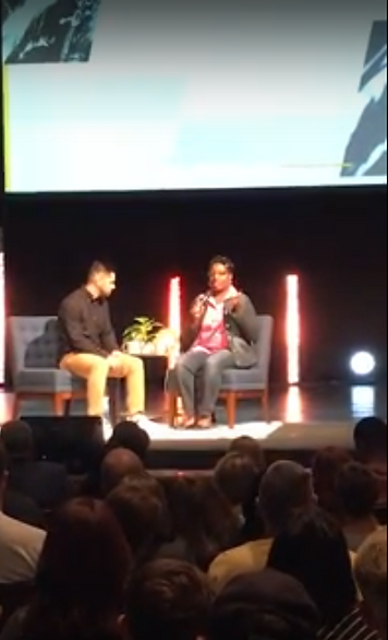 Joy Scott being interviewed on stage in front of an audience