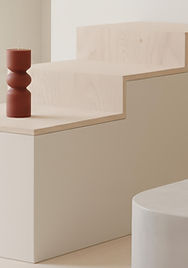 Minimal display space with folded clothing and shoes on wooden platforms