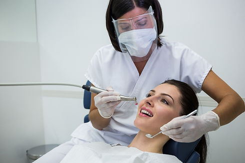 dentist-examining-female-patient-with-tools.jpg