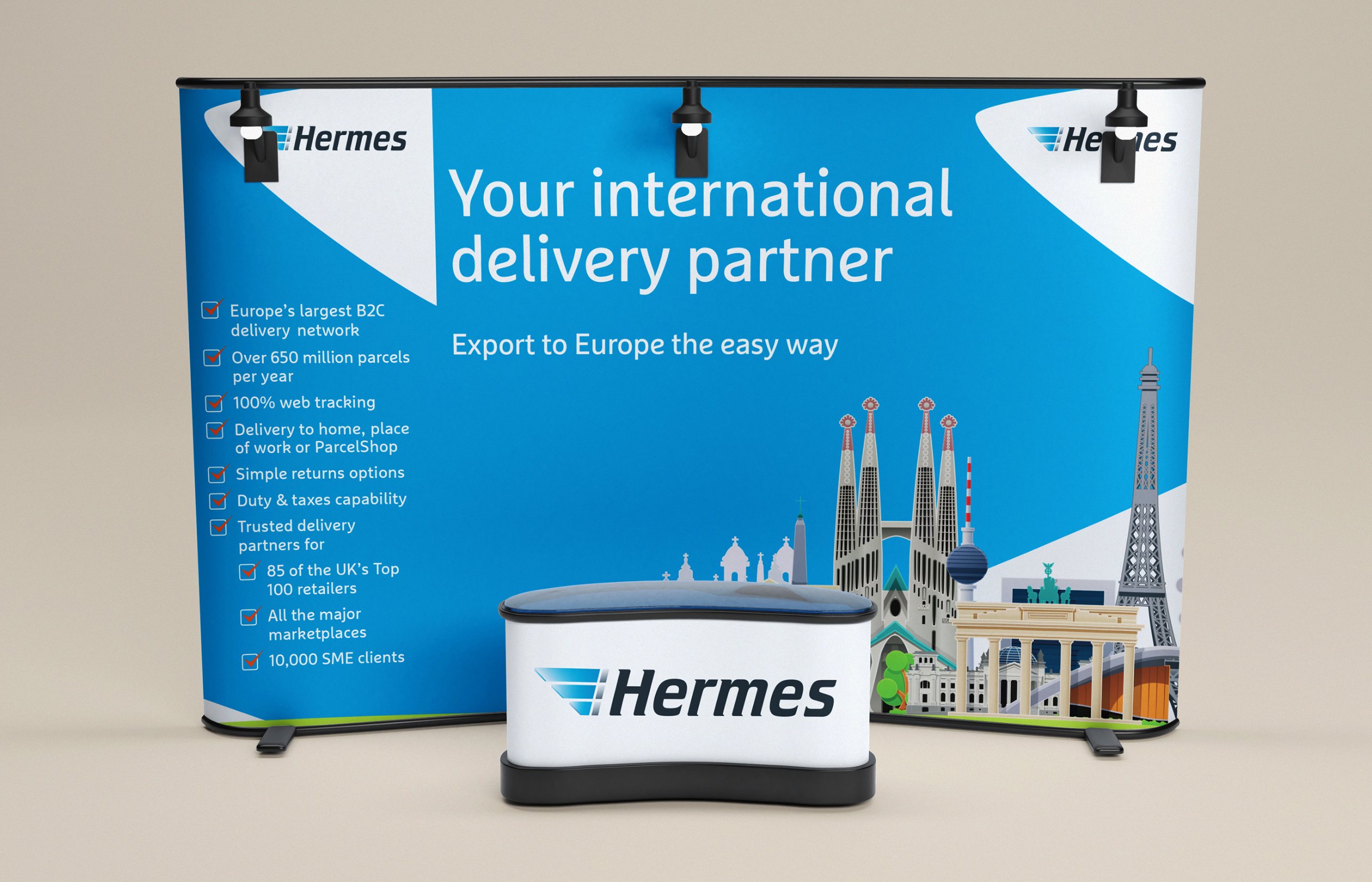 Hermes expo stand: Your international delivery partner, with illustrated European landmarks and a branded counter