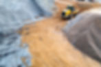Construction aggregates and recycled materials stockpiled at an Ontario Trucking & Disposal yard, supporting Toronto-area construction projects.