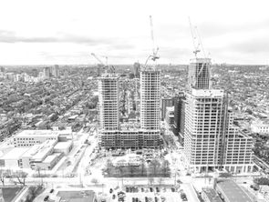 Aerial view of the 74 Croatia Street high-rise development in Toronto's Dufferin Grove neighbourhood with a JCL Concrete Pumping boom pump placing concrete on one of the towers.