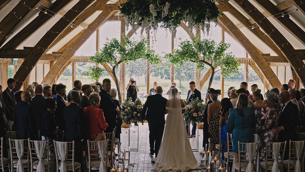 Wedding reception setup at Sandburn Hall, featuring rustic wooden beams and stylish decor