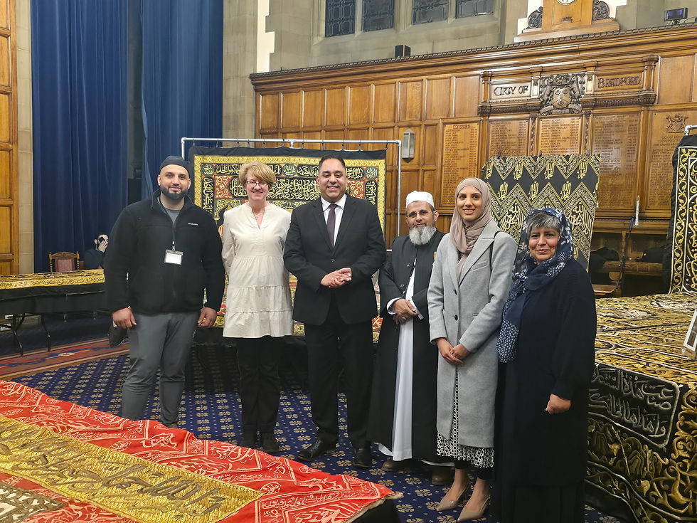 Imran Hussain MP stands with Susan Hinchcliffe, Sheikh Ilyas, Dr Sofia Buncy, Aneela Ahmed, and Taus