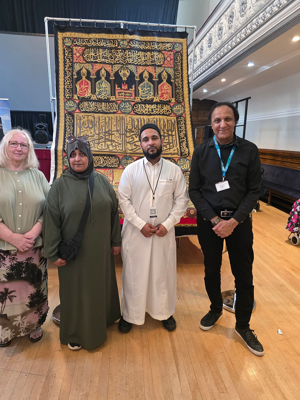 Cllrs Cathy Scott, Hanifa Darwan, and Masood Ahmed stand with Hafiz Yusuf for a group photo in front