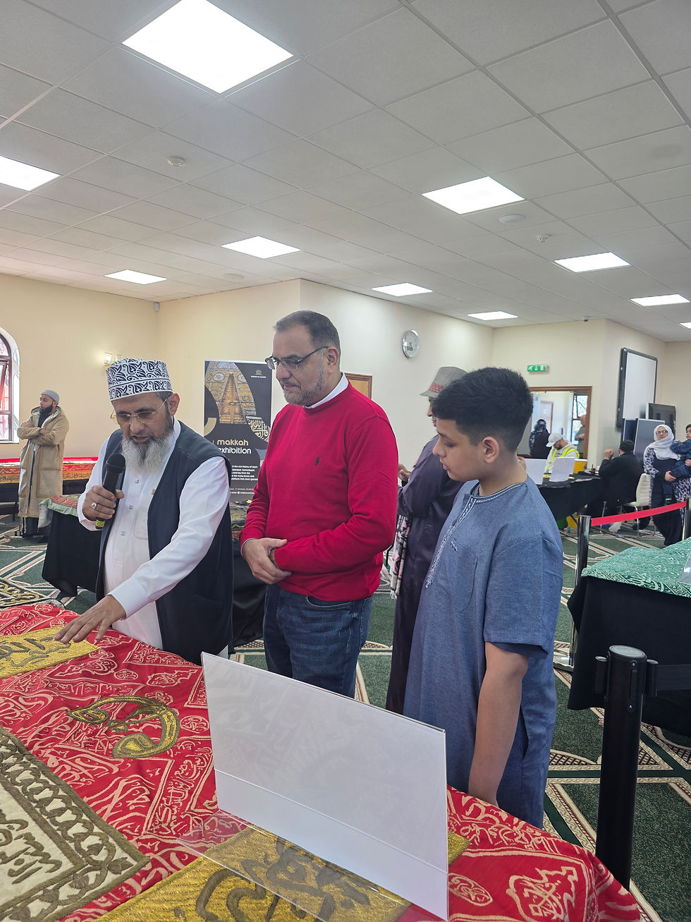 Sheikh Ilyas points to a historic Kiswah panel, explaining the differences in materials, design, and