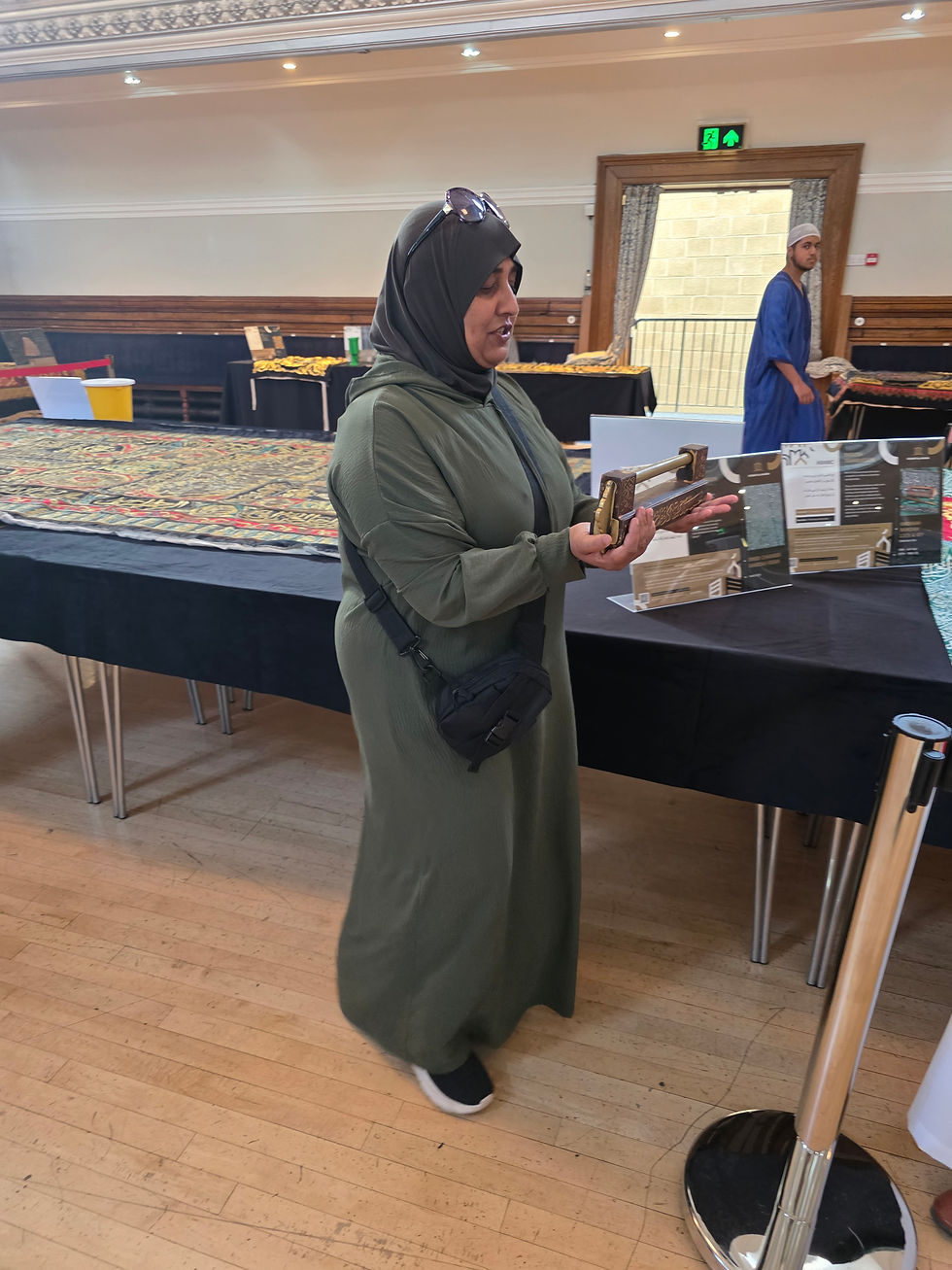Cllr Hanifa Darwan holds the sacred Rawdah Lock in her hands, eyes filled with awe and emotion, duri