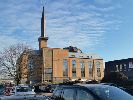 Visitors admire sacred Islamic relics, including the Kiswah and Kaaba locks, at Harrow Central Mosque's historic exhibition